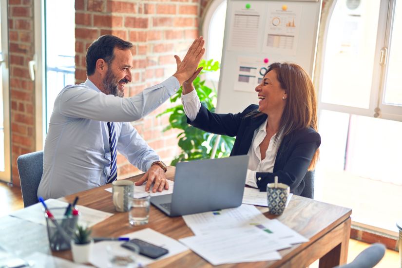 man and woman high five each other, middle managers being successful